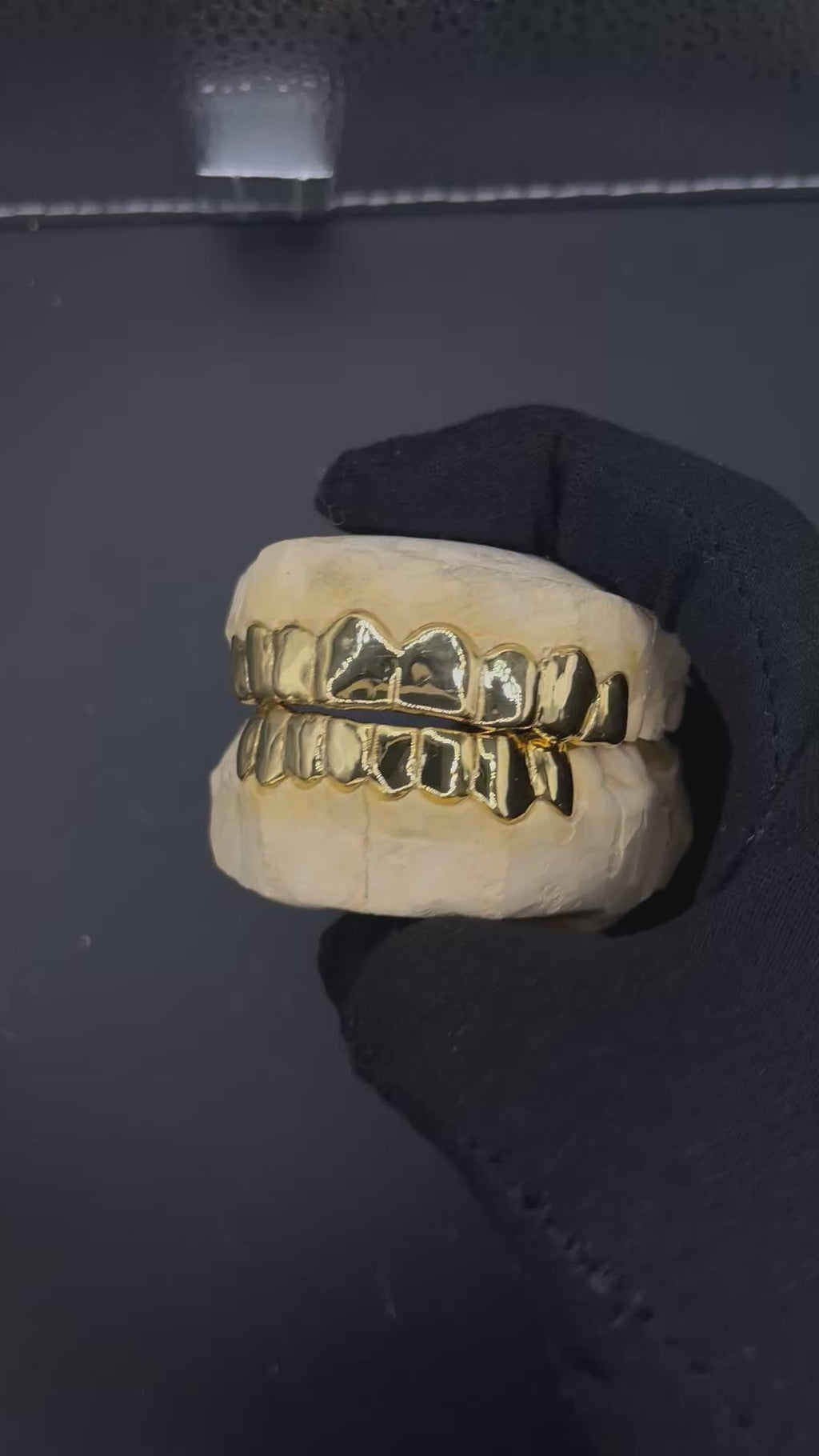 Custom solid gold grillz on dental mold