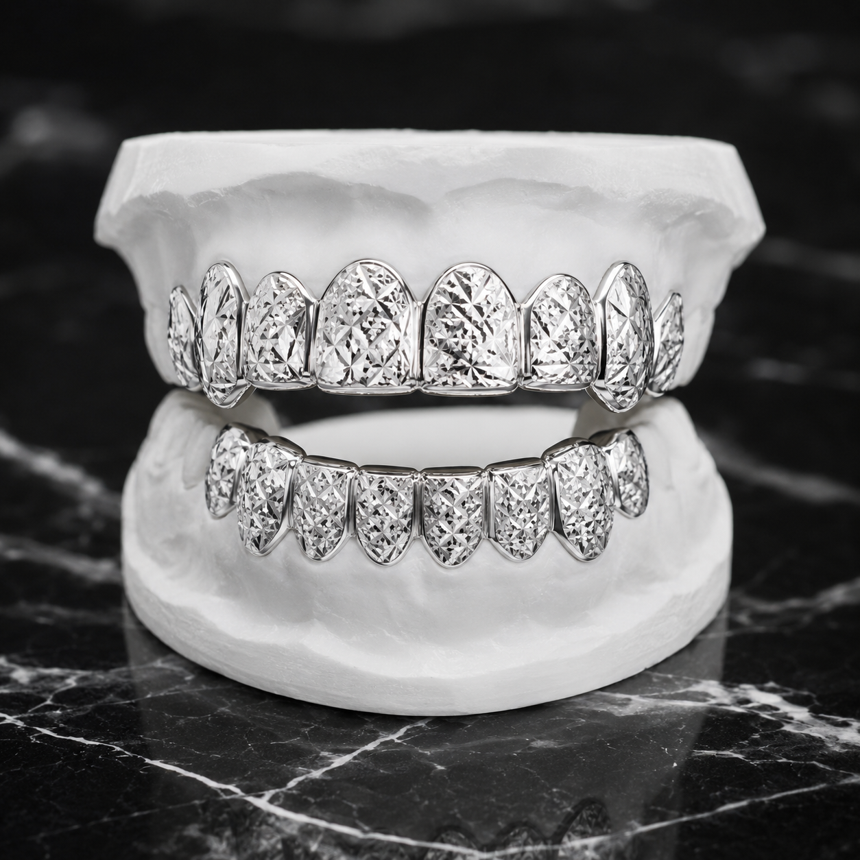 Custom Silver Diamond Cut Grillz Set with precision diamond-cut sparkle finish on sterling silver, displayed on a white dental mold over black marble.
