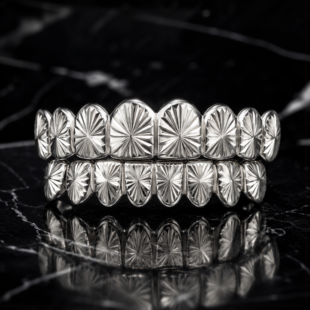 Handcrafted Silver Sunburst Mirror-Cut Grillz made from polished 925 sterling silver with precision engraved mirror-cut detailing and a custom fitted luxury design.